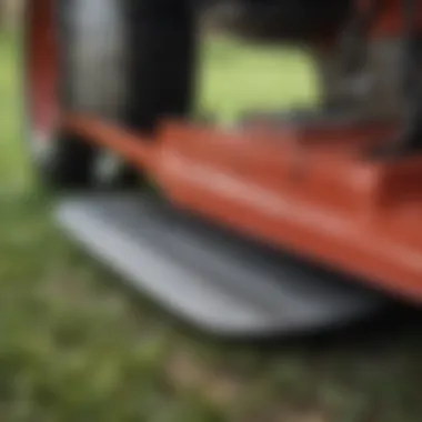 A close-up view of a finish mower's blade and cutting deck