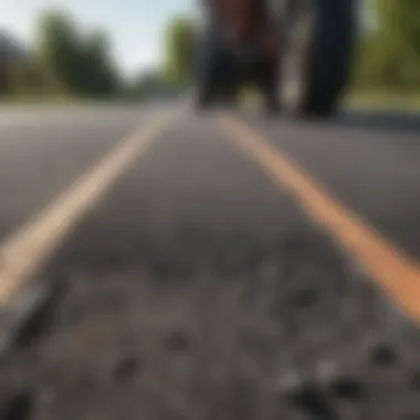 Close-up of asphalt being laid on a road, highlighting texture and quality.