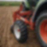 A close-up view of a three point back blade attached to a tractor in a field.