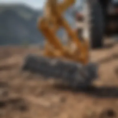 Close-up of a three point rock rake in action on agricultural land