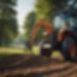 Loader fork attached to a compact tractor in an agricultural setting.